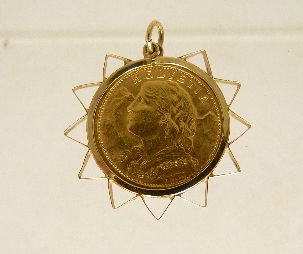 A Swiss gold 20 Franc coin dated 1913, in a star shaped 9ct gold clip pendant mount, total weight