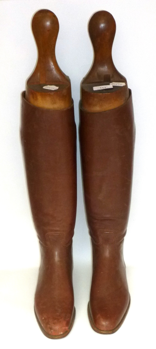 A Pair of Brown Leather Riding Boots, with beech trees