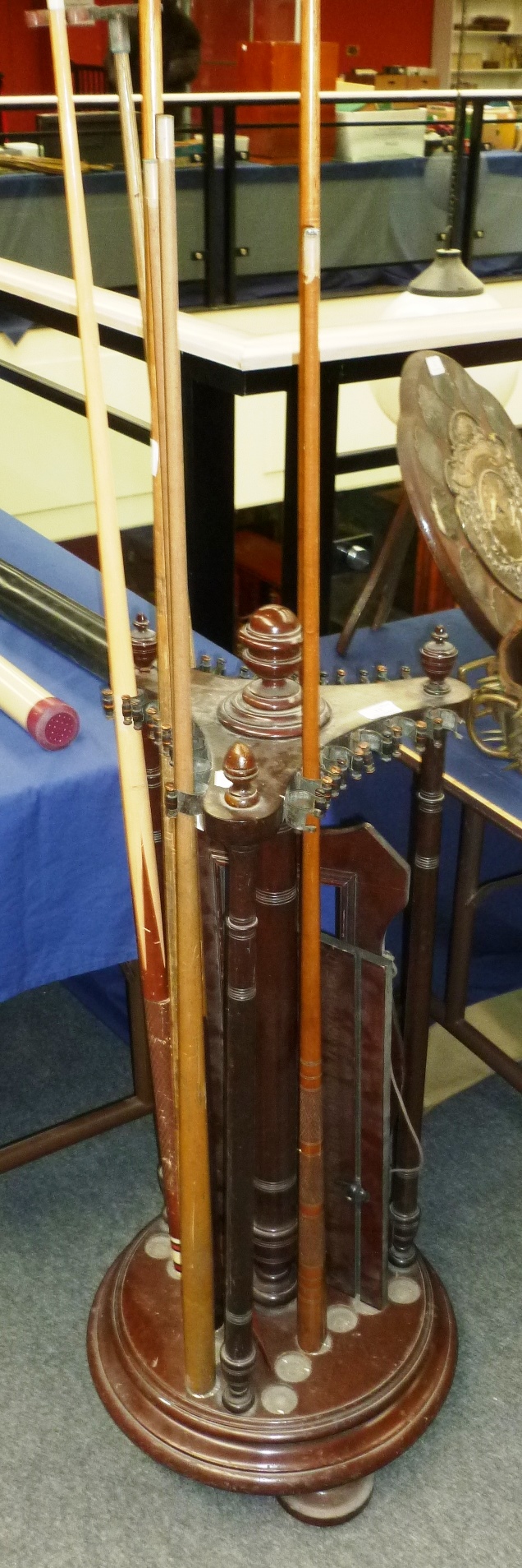 A Revolving Mahogany Snooker Cue Stand, with circular base raised on bun feet, triform top