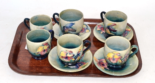 Six Moorcroft coffee cups and four saucers (a.f.) Very heavily crazed, viewing recommended. Two