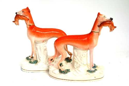 A pair of Staffordshire greyhounds