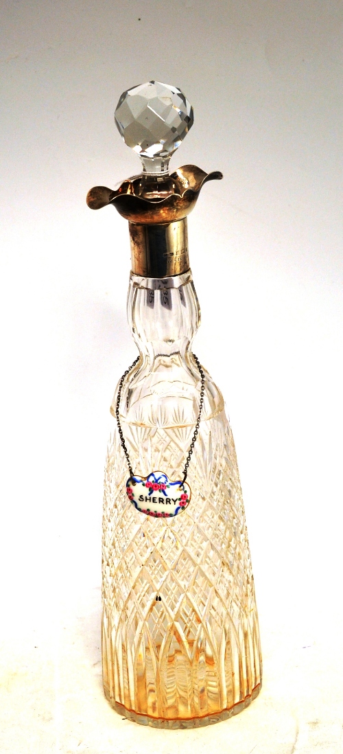A silver mounted decanter and label