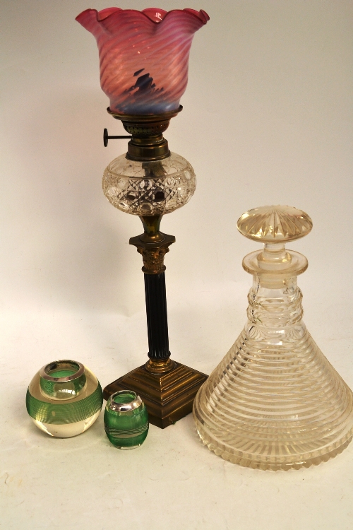 A step cut decanter, two match strikers and an oil lamp