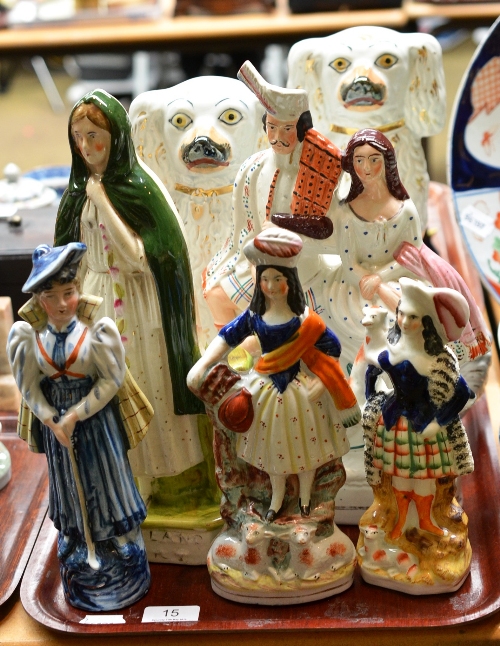 A pair of Staffordshire dogs, four other Staffordshire figures and a Continental lady golfer