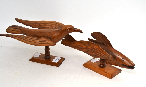 A carved and inscribed Pitcairn Islands model bird on stand and a similar flying fish