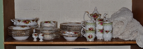 A Royal Albert Old Country Roses part dinner and tea service, two crocheted cloths and embroidered
