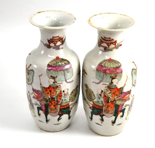 A pair of early 20th century Chinese `famille rose` vases, 23.5cm high Small chips and areas of
