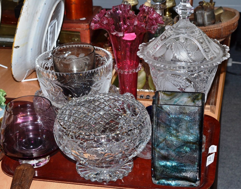 A tray of decorative glass including a cranberry trumpet vase