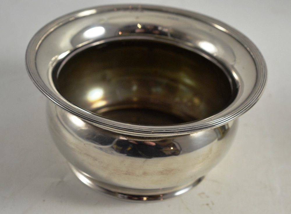 A George V plain bowl, Birmingham 1913, with reeded everted rim and cushion compressed body, 14cm