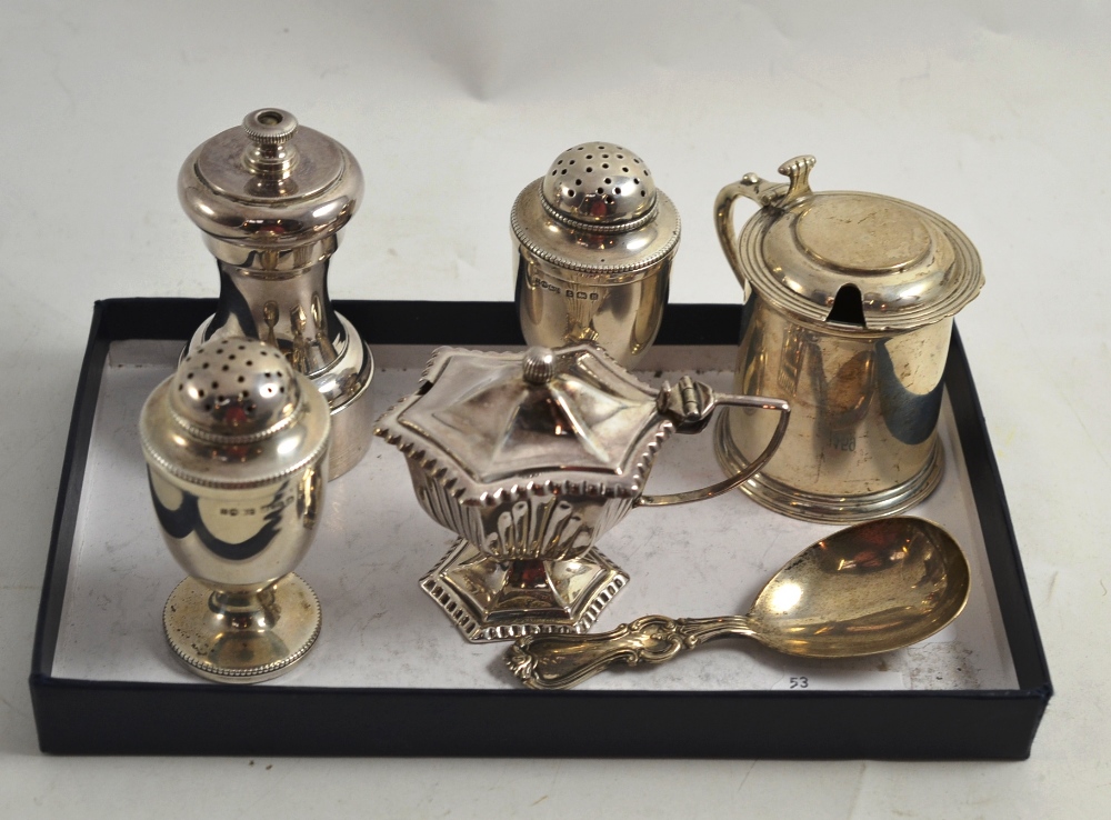 Pair of silver pepperettes, two silver mustards, silver caddy spoon and plated pepper grinder