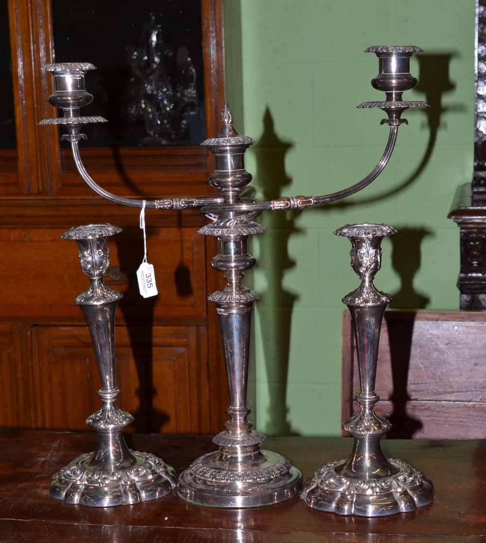 A pair of plated candlesticks and a plated candelabrum