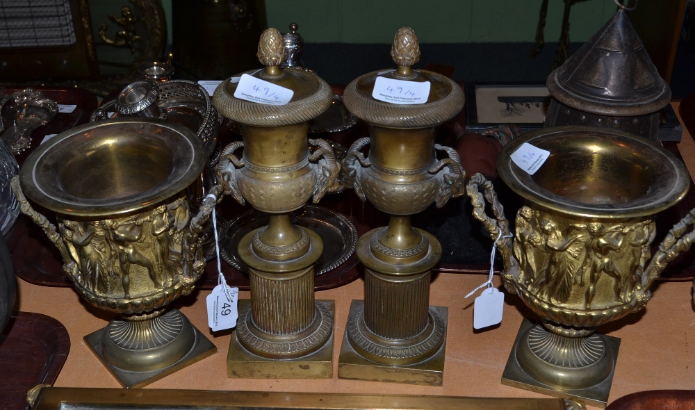 Pair of gilt metal twin handled pedestal vases and pair of loaded pedestal vases with rams head