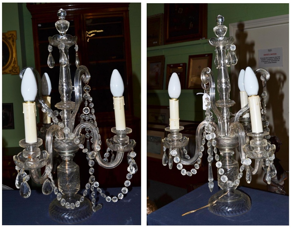 A pair of cut glass three branch table light fittings with faceted drops