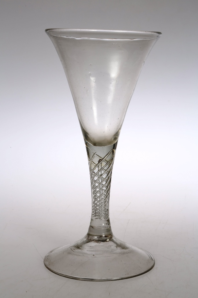 A mid 18th century soda glass wine, of drawn trumpet form with air twist stem, on a conical foot.