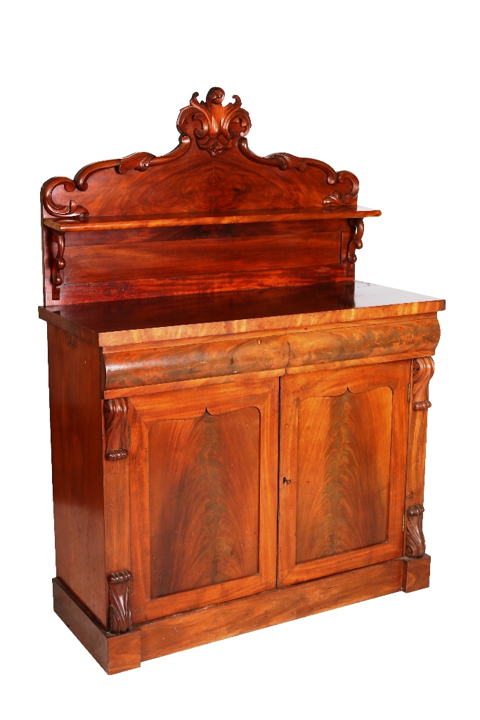 A small Victorian mahogany chiffonier, the leaf and scroll carved shelved back above a rectangular