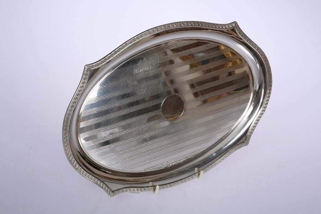 A George V silver tray, W.J. Myatt & Co, Birmingham 1929, of shaped oval form with Greek Key cast
