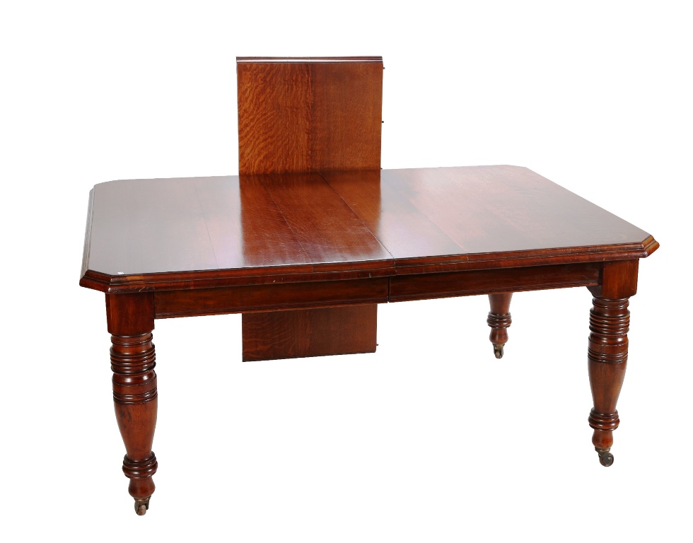 A Victorian oak wind-out extending dining table, the moulded rectangular top with cut-off corners,