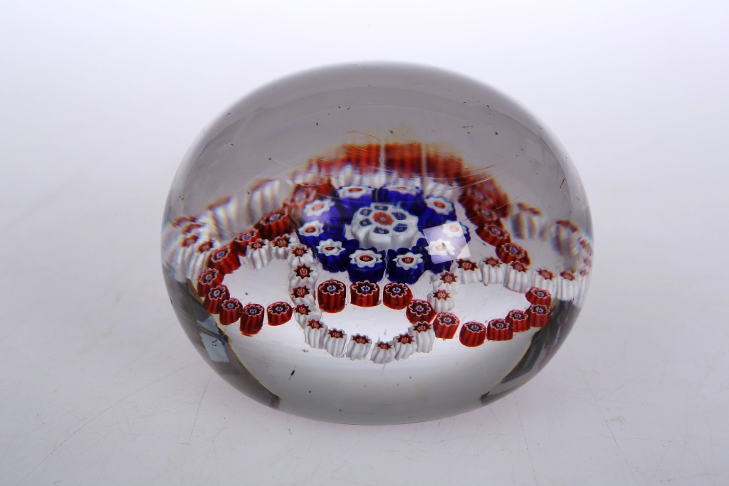 A French paperweight, in Baccarat style, with a design of interlaced garlands within clear glass.