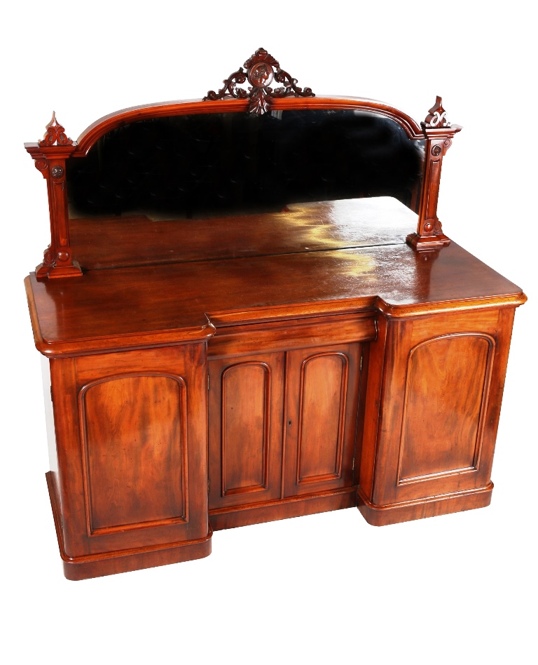 A mid 19th century mahogany chiffonier, the mirror superstructure with pierced and leaf carved