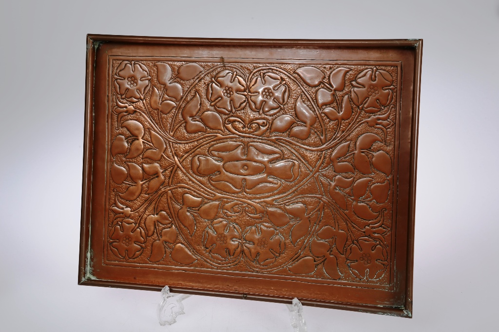 An Arts & Crafts copper tray, attributed to the Keswick School, of rectangular form with rolled rim,