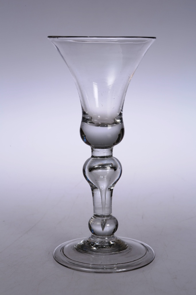 A mid 18th century wine glass, with bell bowl above a double knopped stem and folded foot. 16.5cm