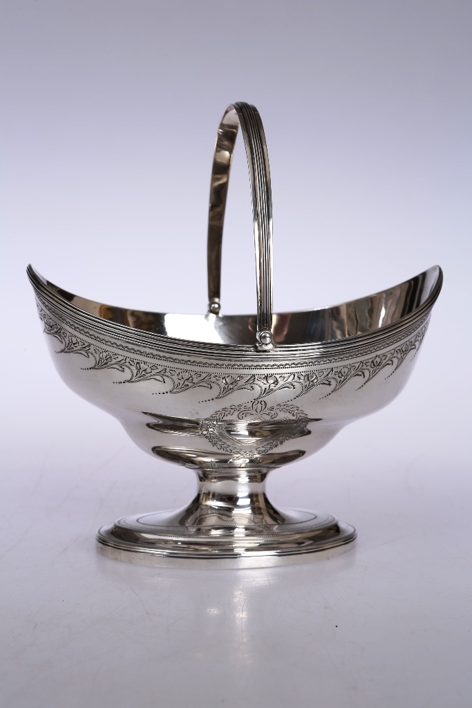 A George III silver sugar basket, George Bateman, London 1797, oval with reeded swing handle and