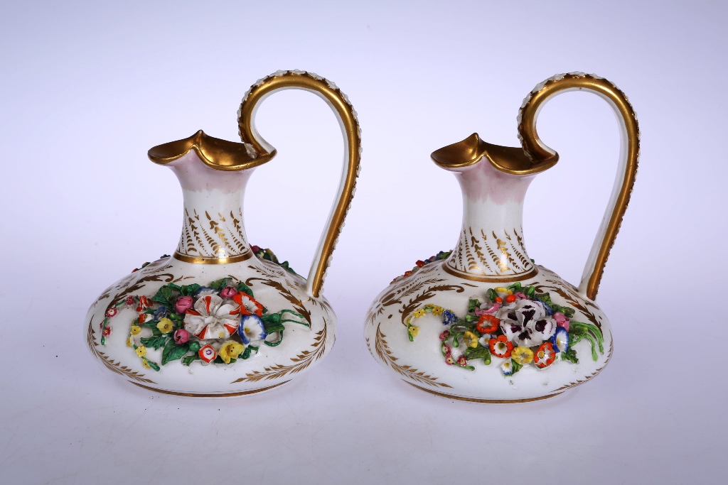 A pair of Derby porcelain ewers, circa 1820's, each squat body picked out with gilded sprigs and