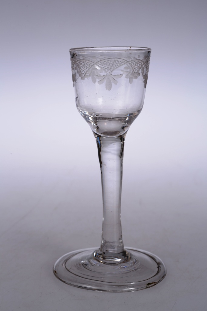 A mid 18th century cordial glass, with etched bucket bowl and folded foot. 14.5cm