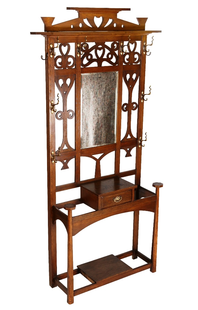 An Arts & Crafts oak hallstand, the pediment with heart-shape cut-out above carved and pierced