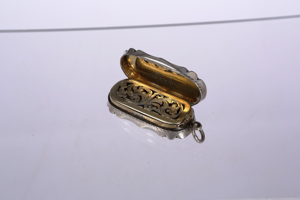 A Victorian silver vinaigrette, Birmingham 1886, of shaped rectangular form, engraved with