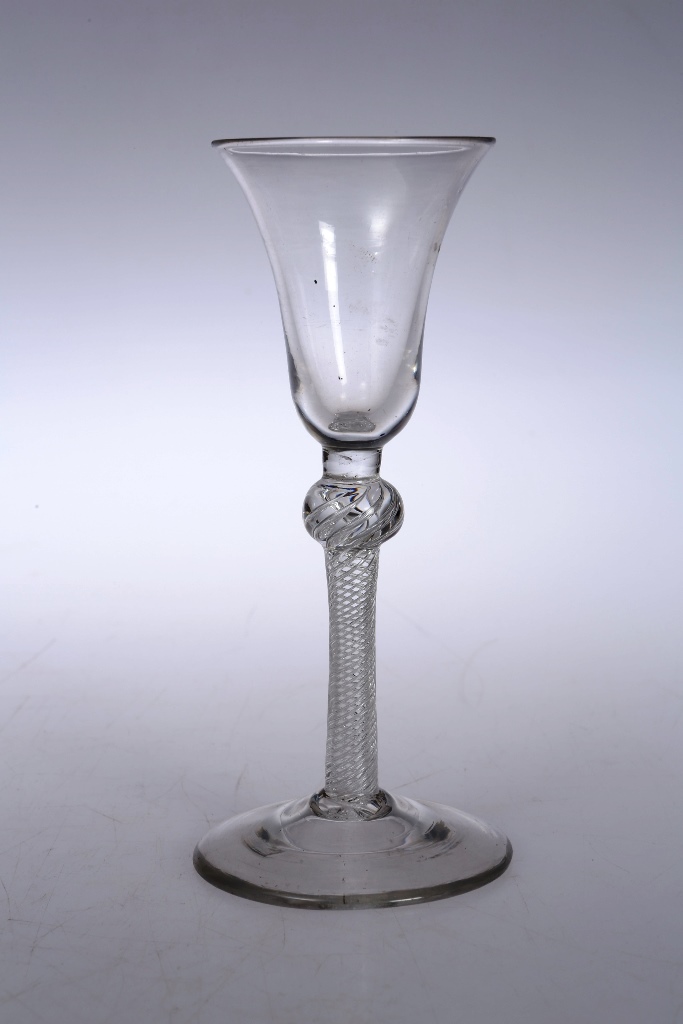 A mid 18th century wine glass, the bell bowl above a knopped air twist stem, raised on a domed