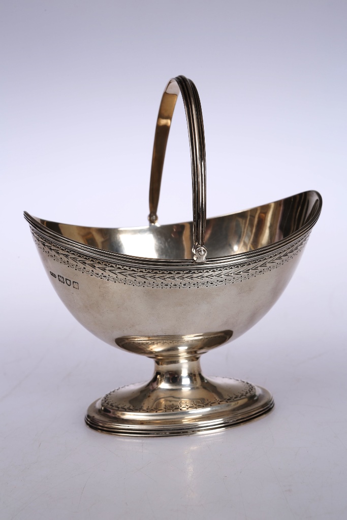 A Georgian style silver sugar basket, John Henry Rawlings, London 1912, oval with swing handle and