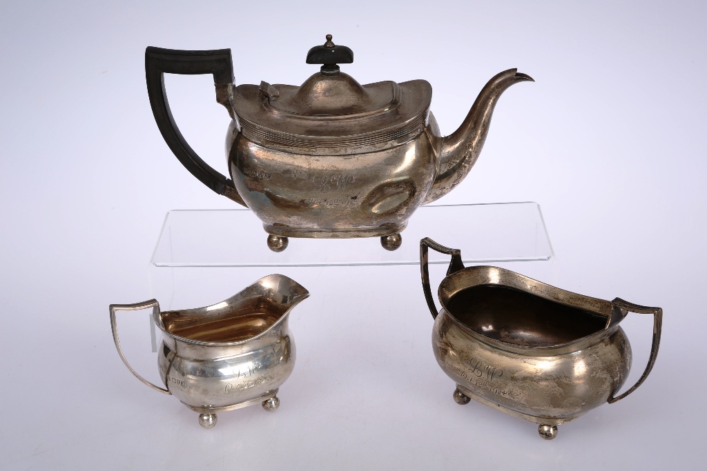A George V silver three-piece tea service, Barker Bros., Chester 1923, comprising teapot, cream