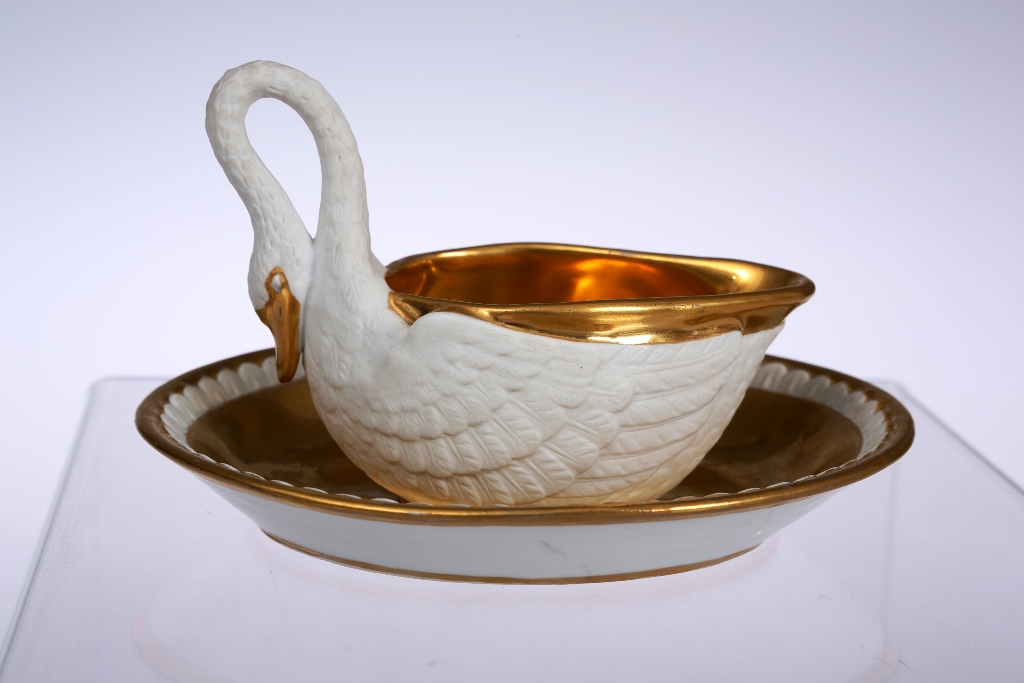 A Paris porcelain sauce boat on stand, 19th century, probably by Darte Freres, in the form of a