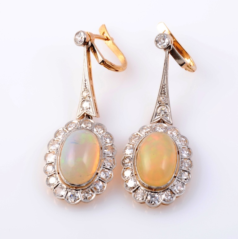 A pair of opal and diamond earrings, each oval cabochon-cut opal collet set with a bezel of sixteen