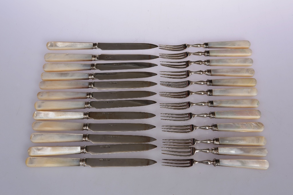 Twelve pairs of silver and mother of pearl handled dessert knives and forks, variations in dates