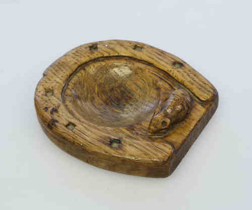 An early Robert "Mouseman" Thompson oak ashtray, unusually carved as a horseshoe, with carved
