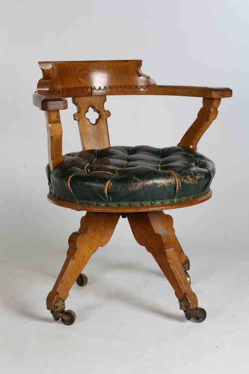 A Victorian golden oak and upholstered rotating desk chair, in the Arts & Crafts style, the