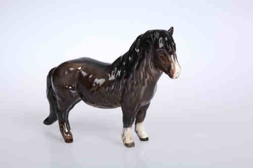 A Beswick model of a Shetland pony, no. 1033, brown gloss. 14.5cm