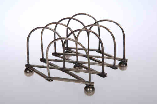 A Victorian silver-plated articulated muffin rack, in the manner of Christopher Dresser, composed of