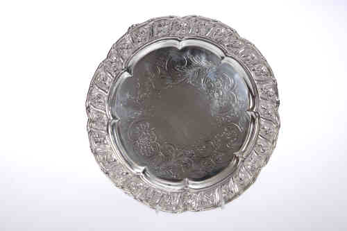 A George IV silver salver, Joseph Craddock, London 1825, the shaped rim enclosing a band of