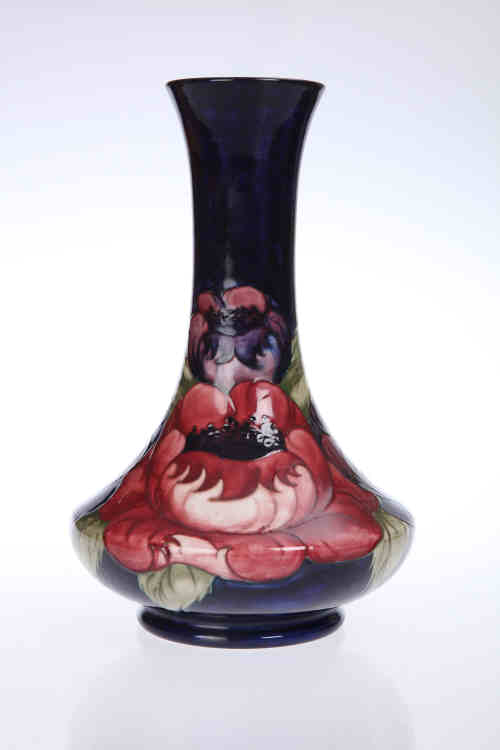 A William Moorcroft "Big Poppy" pattern pottery vase, the squat body issuing a long neck,