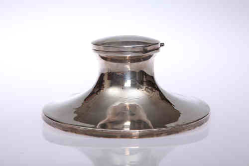 A George V silver inkwell, Chester 1911, of characteristic form, (weighted). Diameter 17cm