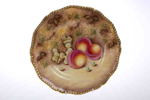 A Royal Worcester fruit painted plate, painted by R. Price within a "beaded" and gilded rim, black