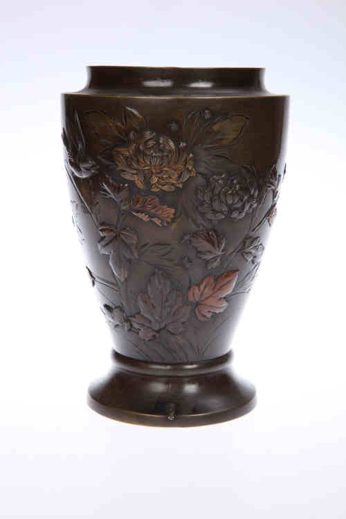 A Japanese bronze vase, Meiji period, engraved and applied with a bird amidst foliage of differing