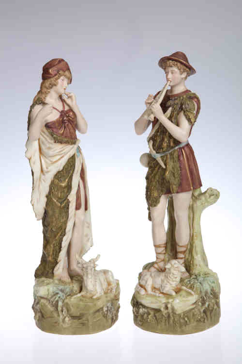 A pair of Royal Dux figures, modelled as a Shepherd and Shepherdess, no. 351 and 352, each applied