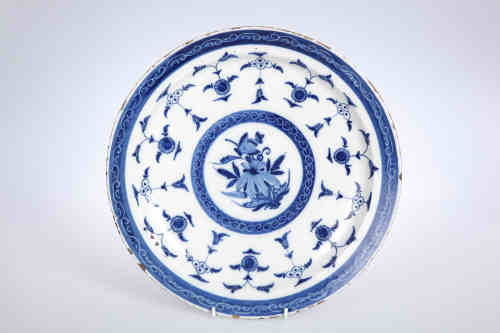 A Dutch Delft blue and white dish, 18th century, the circular plate painted to the centre with a