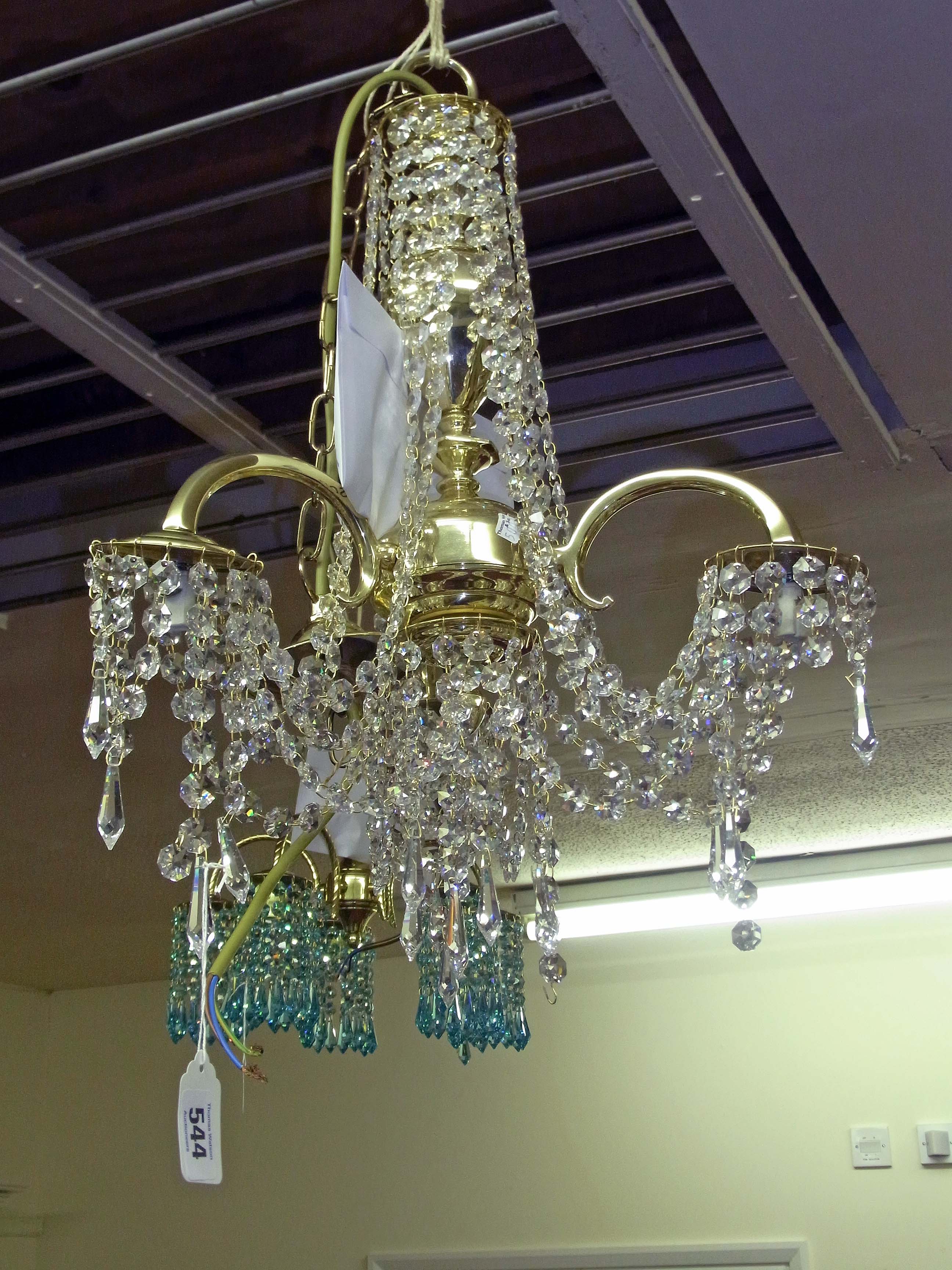 A brass and Swarovski lead crystal three light ceiling fixture, each drop with lazer etched mark.