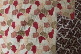 An early twentieth century hand stitched quilt with paisley border. CONDITION REPORT: Good.