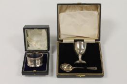 A silver egg cup and spoon, together with a silver napkin ring, both parts cased. (2) CONDITION